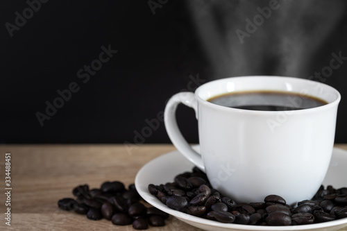 Close up of hot Coffee in white cup with coffee bean on wooden vintage retro background