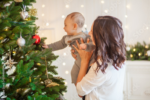 young mother with her son near the Christmas tree