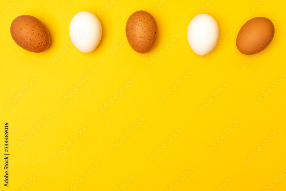 .Easter eggs on a yellow background, place for an inscription below .Easter eggs on a yellow background, place for an inscription below