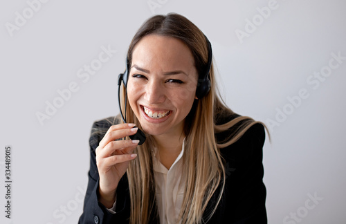 Young woman working in call center. Customer support woman in office