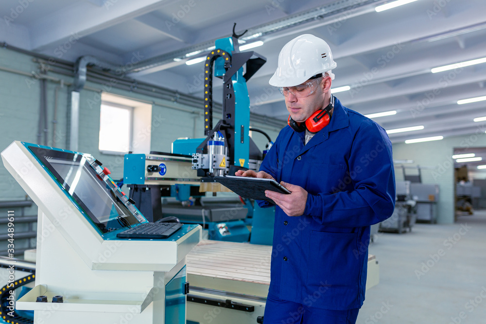 Worker in the Hard Hat Modern Factory CNC machine operator . Successful, Handsome Man in Modern Industrial Environment.Emotions, Copy Space
Worker in the Hard Hat Modern Factory CNC machine operator . Successful, Handsome Man in Modern Industrial Environment.Emotions, Copy Space