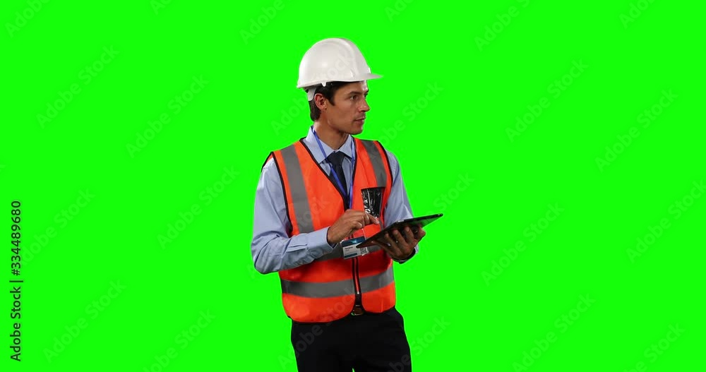 Front view of a site foreman using digital tablet with green screen Front view of a site foreman using digital tablet with green screen