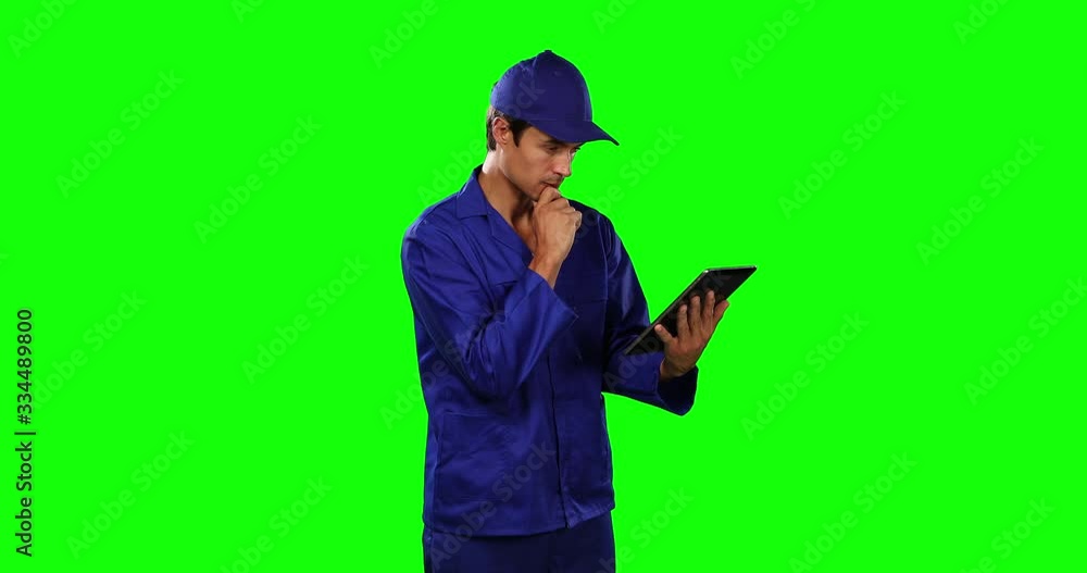 Front view of mechanic using digital tablet with green screen Front view of mechanic using digital tablet with green screen