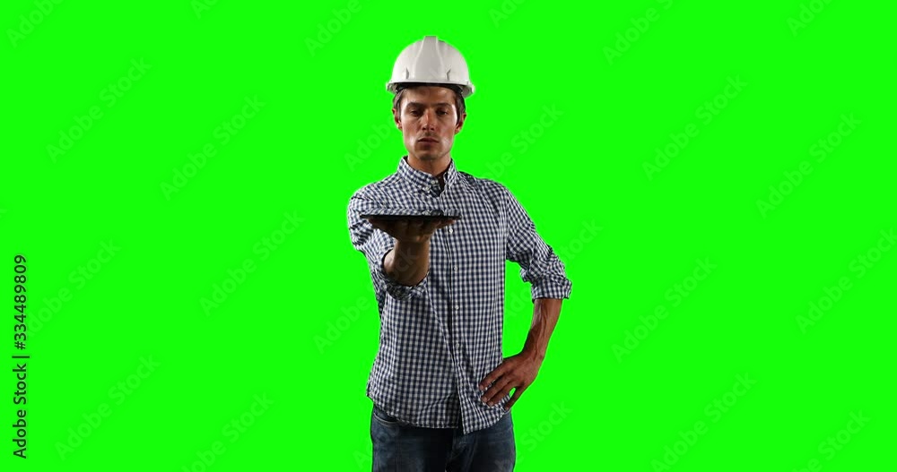 Front view of site worker holding a digital tablet with green screen Front view of site worker holding a digital tablet with green screen