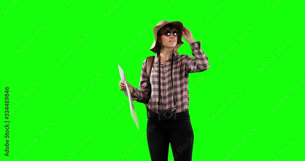 Front view of a tourist Caucasian woman with green screen 