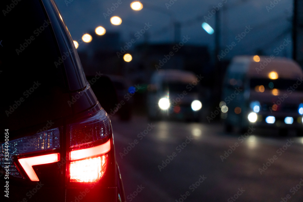 Blurred image of cars on the road with light break at in night.
