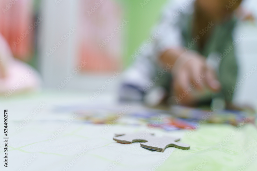 Asian boy about 4 year old building paper jigsaws Asian boy about 4 year old building paper jigsaws