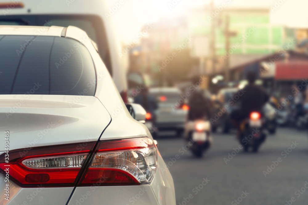 Luxury of whtie car stop beside road. with blurred background evironmnet of transportation in the city. Luxury of whtie car stop beside road. with blurred background evironmnet of transportation in the city.