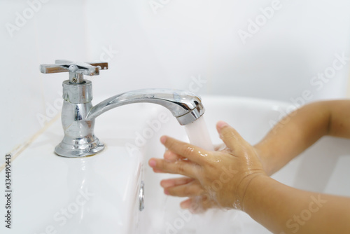 Asian boywashing hands with soap