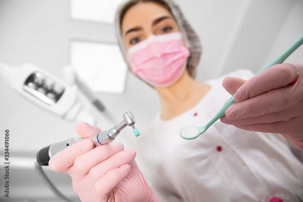 The patient's first-person view at the examination by the dentist lies in the dental chair. Doctor Dental surgeon examines an oral cavity with the help of somatological tools The patient's first-person view at the examination by the dentist lies in the dental chair. Doctor Dental surgeon examines an oral cavity with the help of somatological tools