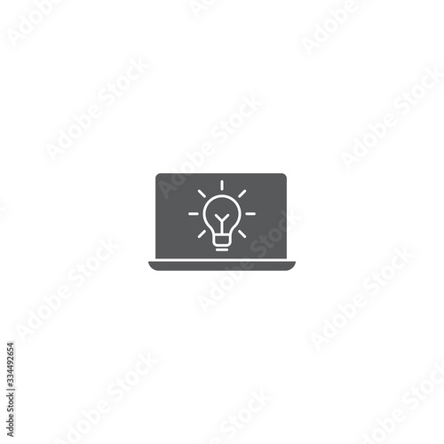 Fototapeta Naklejka Na Ścianę i Meble -  Laptop with light bulb vector icon symbol isolated on white background