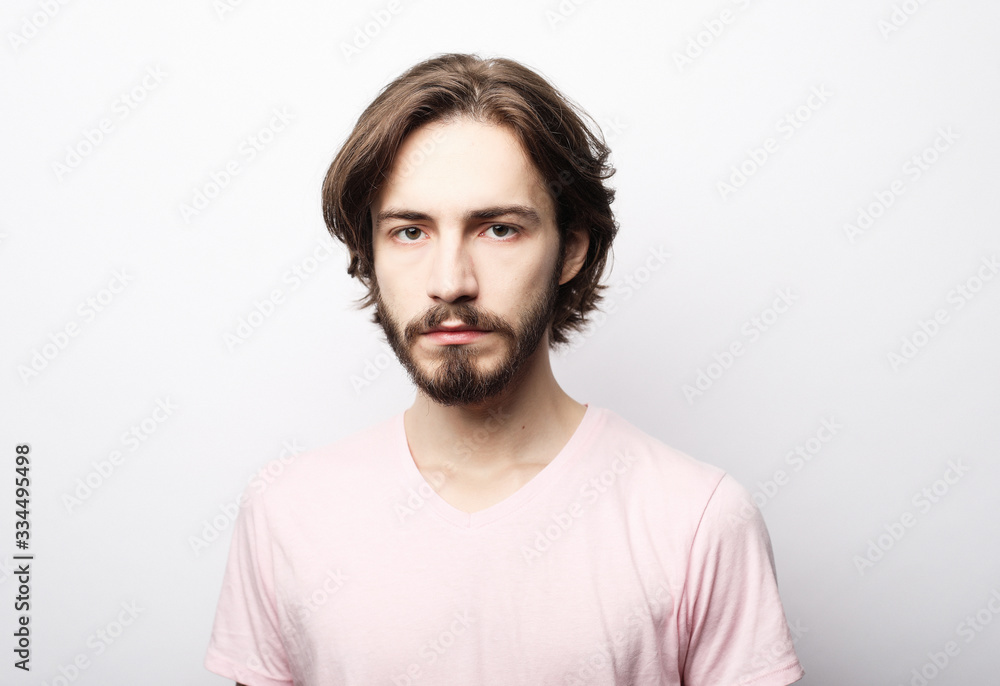 Portrait of young bearded man posing over white background, casual style Portrait of young bearded man posing over white background, casual style