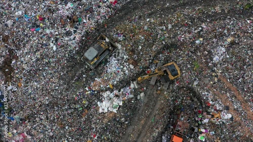 trash on a landfill with bulldozer and excavator