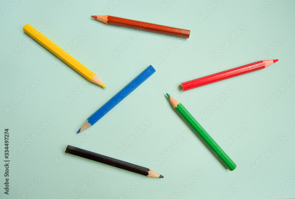 set of color pencils on light blue background set of color pencils on light blue background