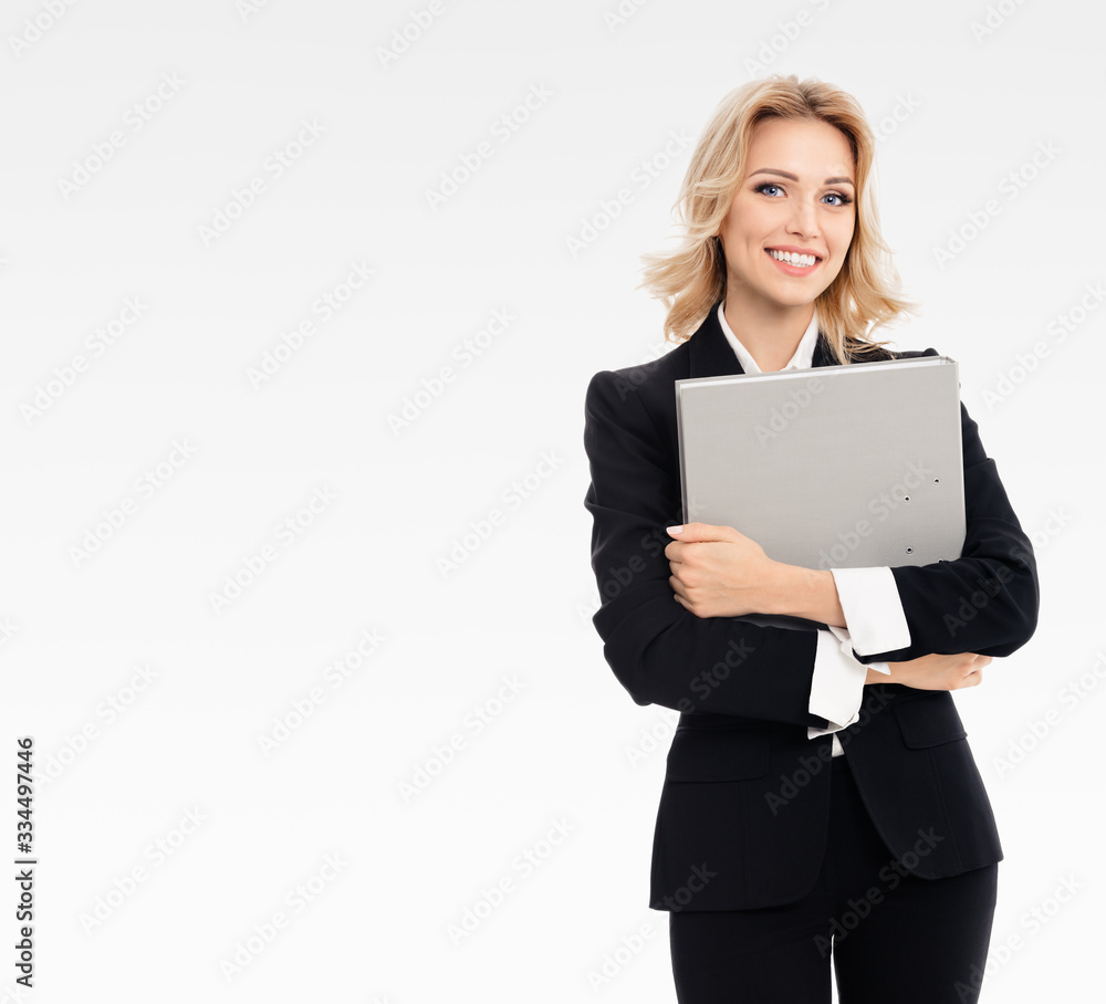Confident businesswoman with grey folder, with copy space area for slogan or text, on grey background. Caucasian blond model in business presentation concept. Confident businesswoman with grey folder, with copy space area for slogan or text, on grey background. Caucasian blond model in business presentation concept.