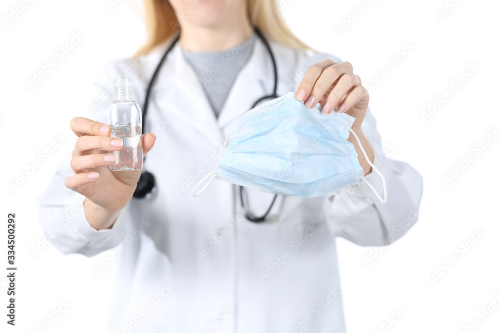 Doctor hands showing mask and sanitizer isolated on white Doctor hands showing mask and sanitizer isolated on white