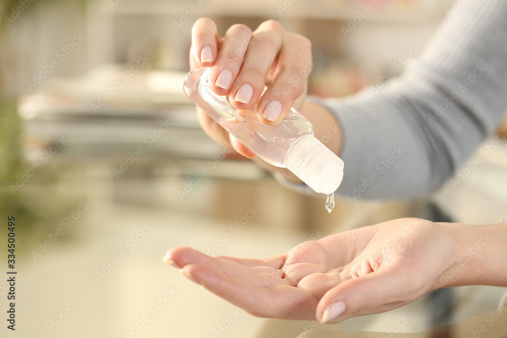 Woman disinfecting hand with sanitizer gel rub - obrazy, fototapety, plakaty 