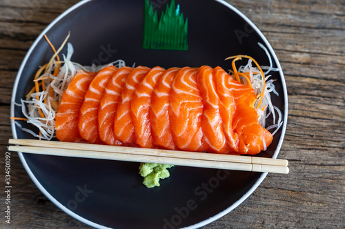 Sliced ​​salmon fillets on a plate on wood Ready to eat