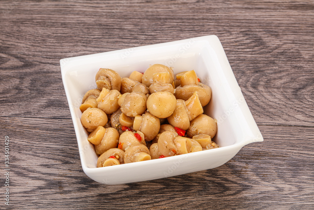 Pickled champignons in the bowl Pickled champignons in the bowl