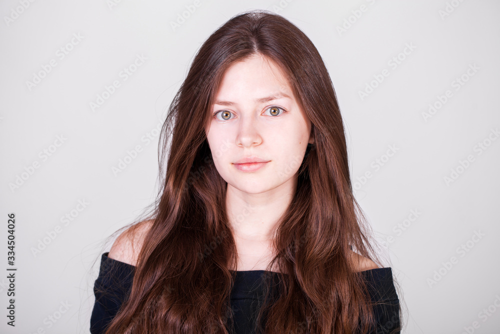 Close up portrait of a young beautiful girl isolated on gray background Close up portrait of a young beautiful girl isolated on gray background