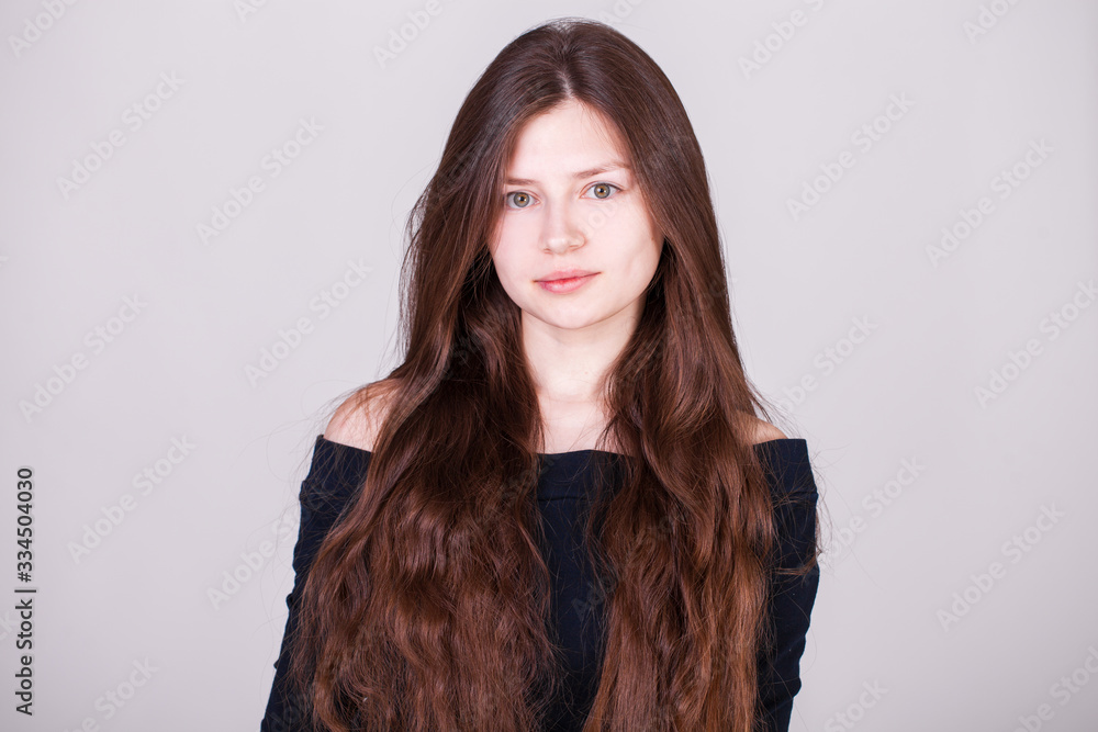 Close up portrait of a young beautiful girl isolated on gray background Close up portrait of a young beautiful girl isolated on gray background