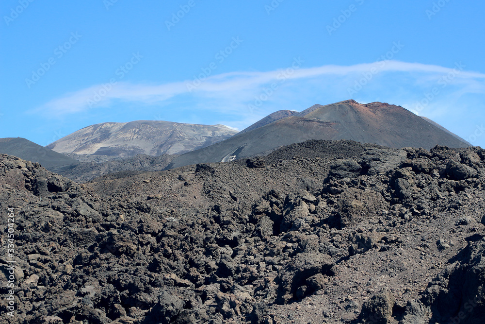 On the way to Volcano Etna through black lava ash fields under blue skies, Sicily, Italy