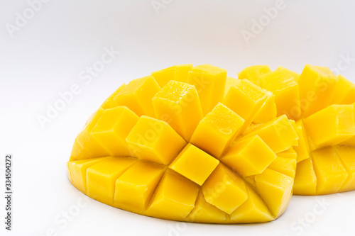 Yellow mango slice with cubes isolated white background