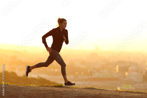 Jogger running at sunset in city outskirts