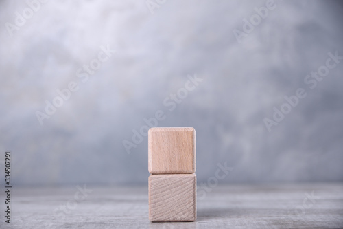 Fototapeta Naklejka Na Ścianę i Meble -  One blank wooden cube with space for your word, letter, symbol on the table. Place for text, free copy space