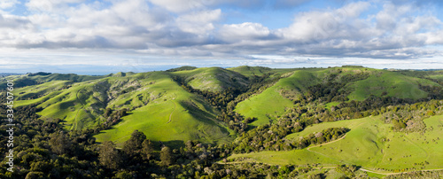Clouds drift above the bucolic hillside scenery in the East Bay of Northern California. This beautiful region is green in the winter and golden in the summer due to seasonal rainfall patterns. © ead72