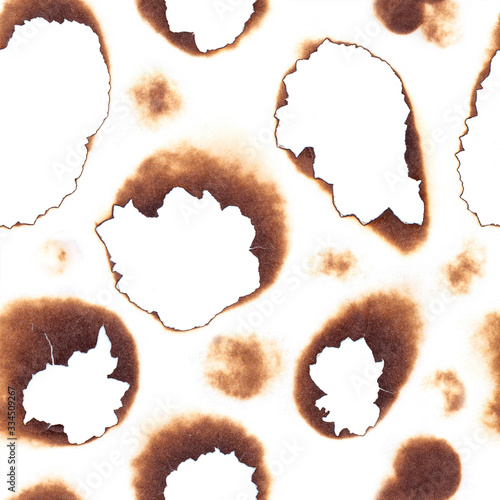Seamless pattern with burned paper texture. Brown marks on paper from fire isolated on white background. Image for your design backgrounds, wallpaper, fabric.