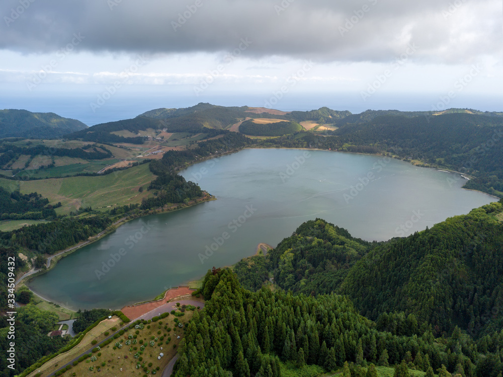 Aerial view of beautiful Furnas lagoon in the Azores islands. Drone landscape view with lines and textures in the background. Top view of volcanic crater, tourist attraction of Portugal.