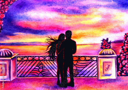 Silhouettes of a hugging couple looking into the distance at the water.