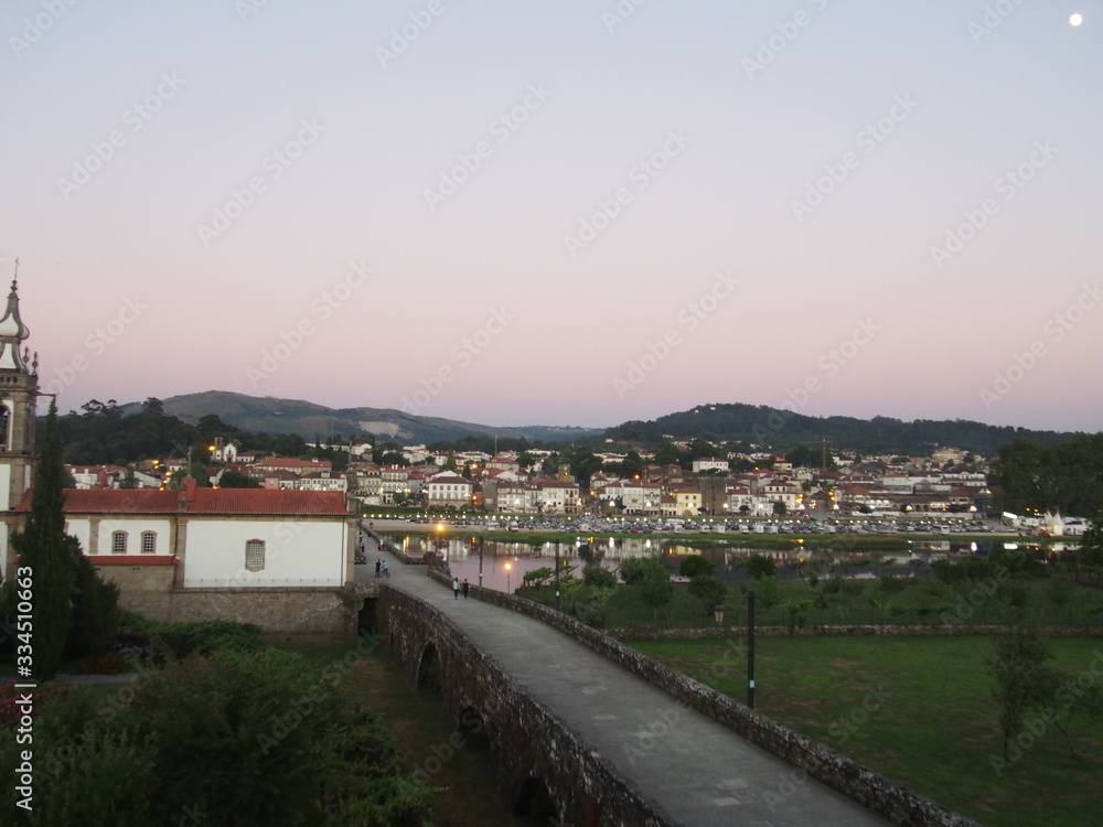 Scenic summer sunset view of the old town and the bridge over the river in Ponte de Lima, Camino de Santiago, Way of St. James, Journey from Barcelos to Ponte de Lima, Portuguese way, Portugal