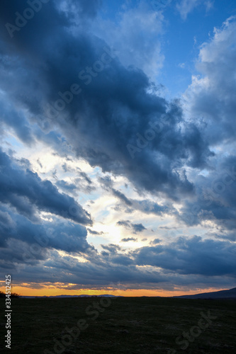 Stormy sky with storm clouns on the sunset with beautiful sun © Ivan