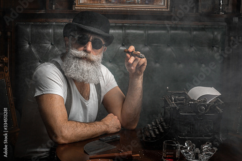 Canvas Print Old man smoking a cigar indoors
