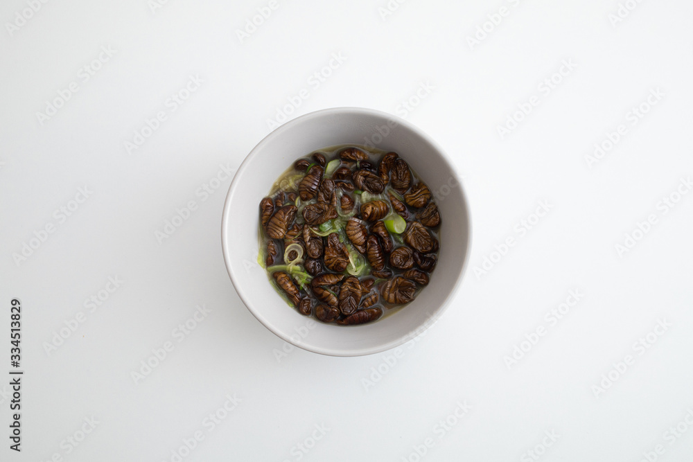 Top view of steamed silkworm chrysalis. Korean name beondegi. Top view of steamed silkworm chrysalis. Korean name beondegi.