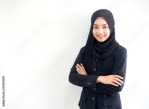 Smart beautiful Asian Muslim woman in modern kurung and hijab.