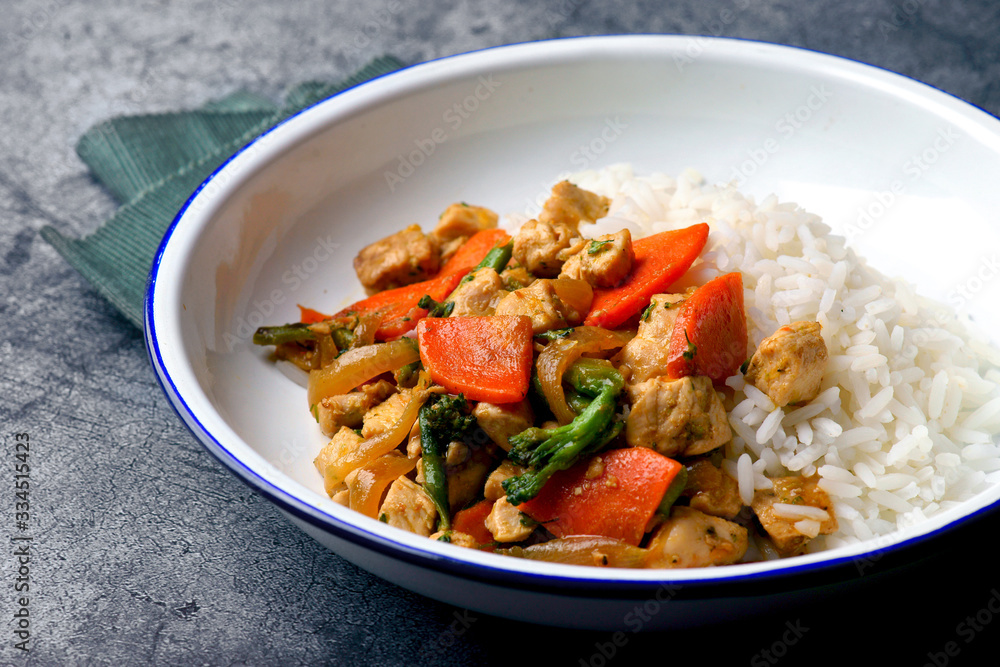 chicken and vegetable sauté with rice on a white plate chicken and vegetable sauté with rice on a white plate