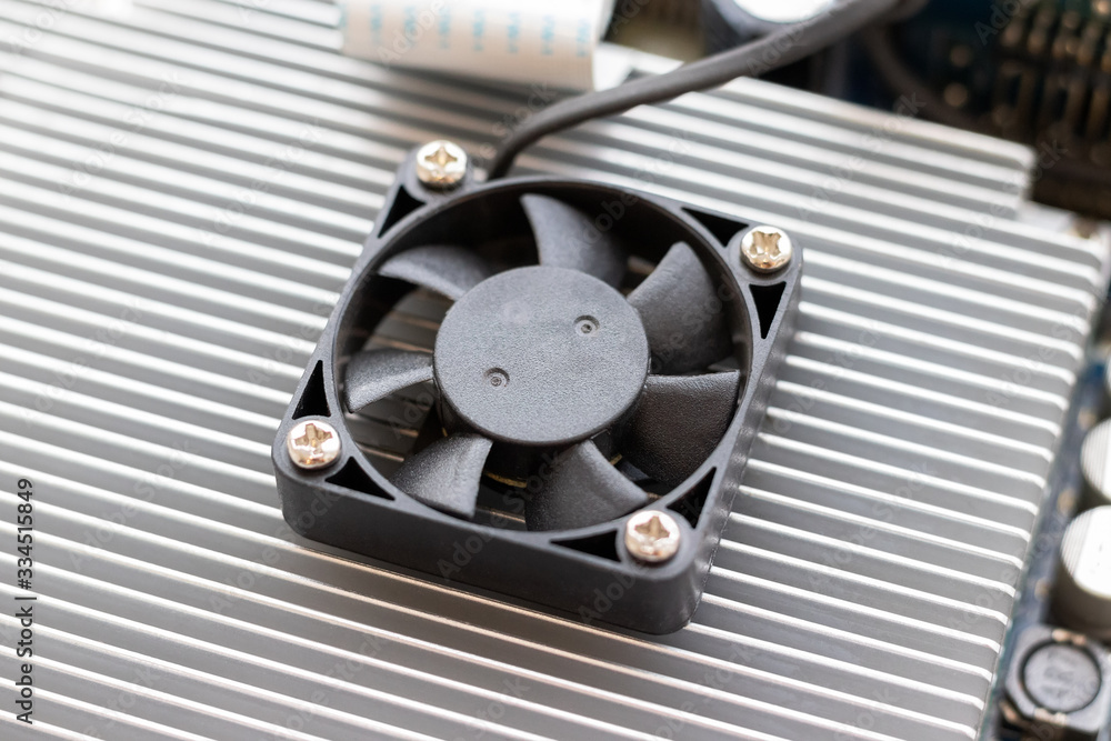Cooling fan. Part of a computer motherboard with cooling radiator. Selective focus. Closeup view Cooling fan. Part of a computer motherboard with cooling radiator. Selective focus. Closeup view