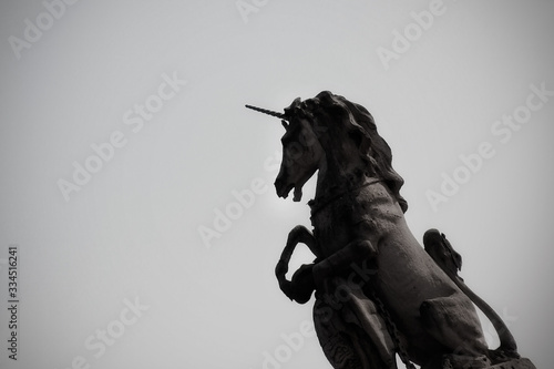 Statue of the Scottish Unicorn on gatepost outside Buckingham Palace in London