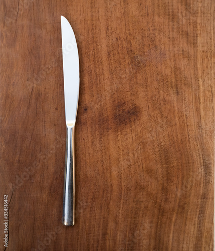 fork and knife on wooden background