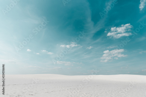 beautiful beach with white sand and blue sky with white clouds © LIGHTFIELD STUDIOS