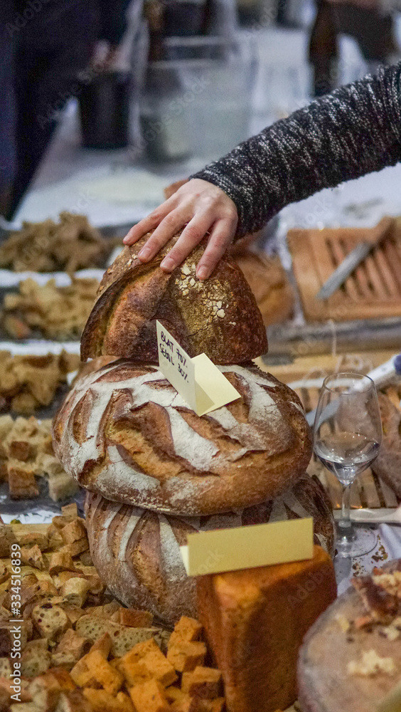 person holding organic bread at a market