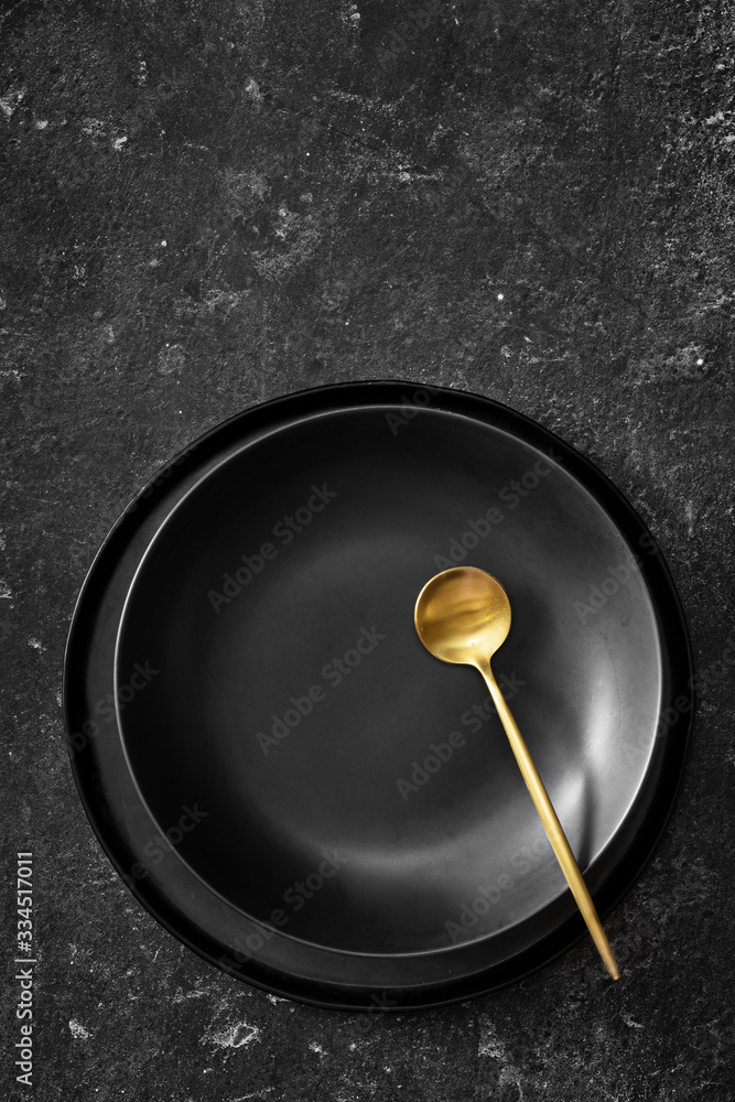 Vertical shot of empty black plate for soup on black bacground Vertical shot of empty black plate for soup on black bacground