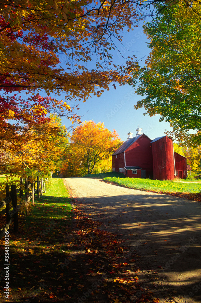 Country barn on a gravel road during autumn in Stowe, Vermont