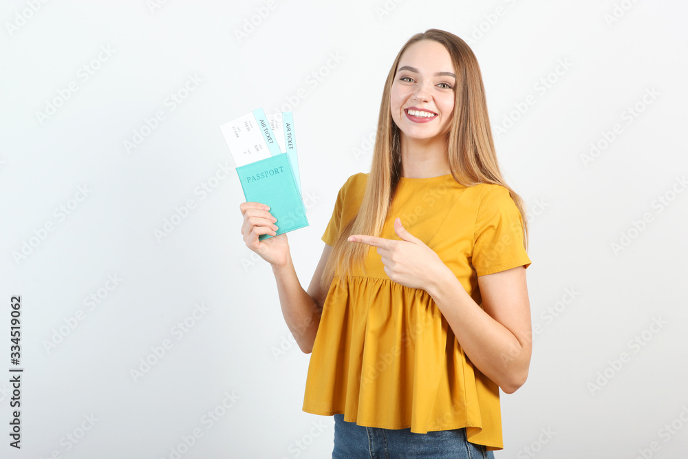 Beautiful young smiling girl holds tickets for travel. Rest, travel, tour. Beautiful young smiling girl holds tickets for travel. Rest, travel, tour.