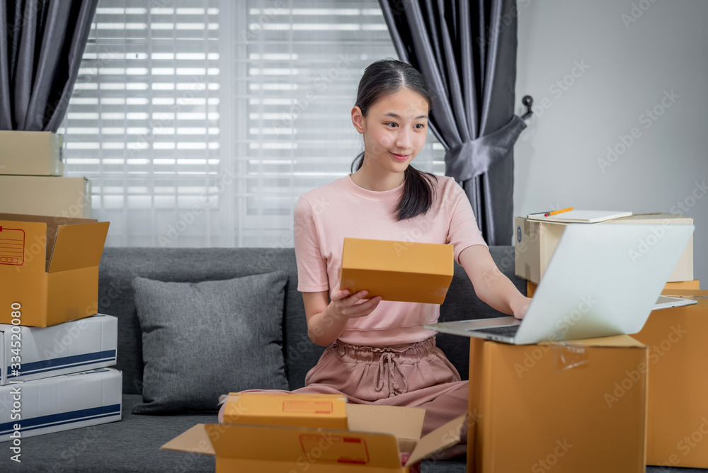 Happy beautiful girl who works at home About Online Business, Prepare goods to customers. Happy beautiful girl who works at home About Online Business, Prepare goods to customers.