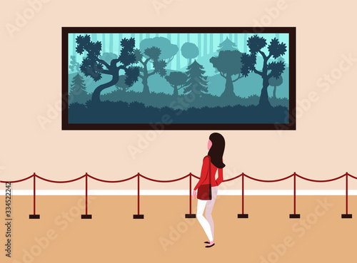 Girl visitor to the Museum stands and looks at a picture of nature.