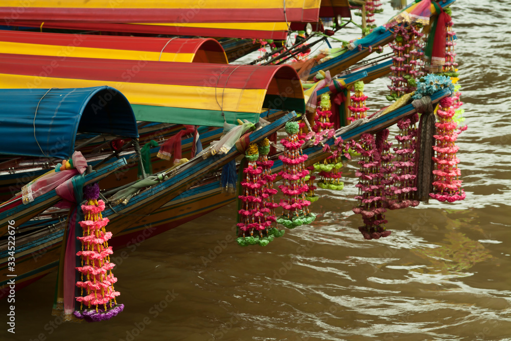 garlands of flowers on the bow of long tail boat in Bangkok, Thailand